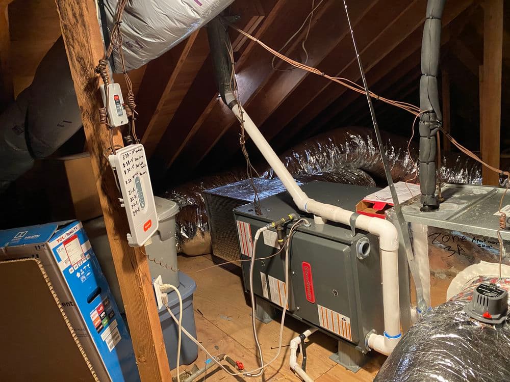 Attic view with furnace and ductwork, showing heating system installation details.